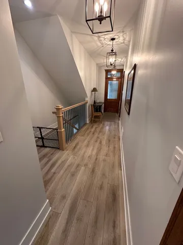 a view of entryway and hall with wooden floor