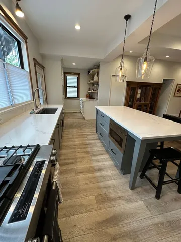 a large kitchen with a table and chairs