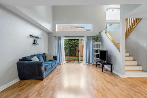 a living room with furniture window and a flat screen tv