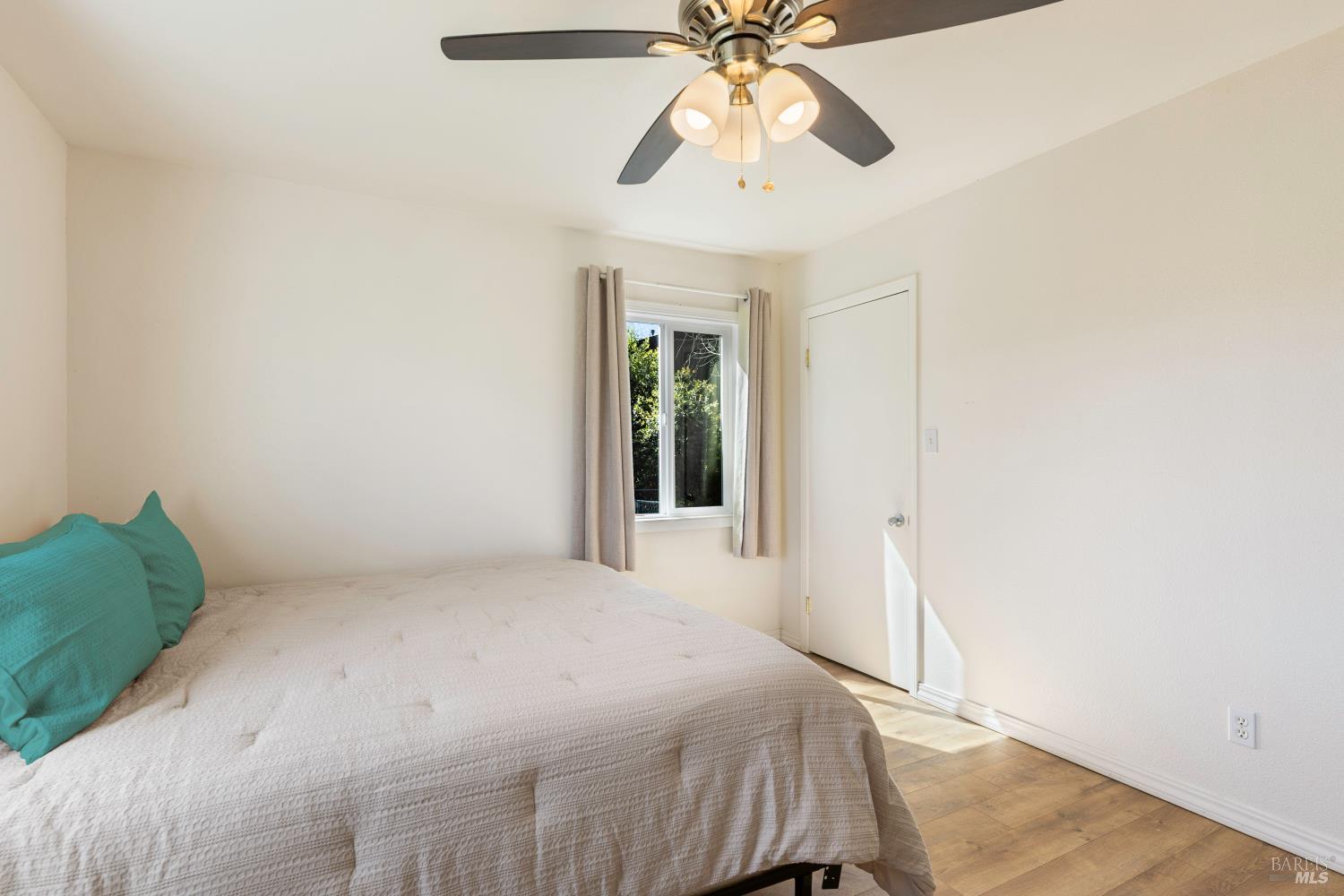 13780 Mountain House Road Hopland, CA 95449 - Photo 14 of 34 a bedroom with a bed and a chandelier fan