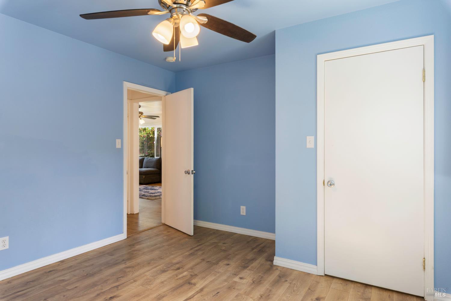 13780 Mountain House Road Hopland, CA 95449 - Photo 20 of 34 an empty room with wooden floor chandelier fan and closet area