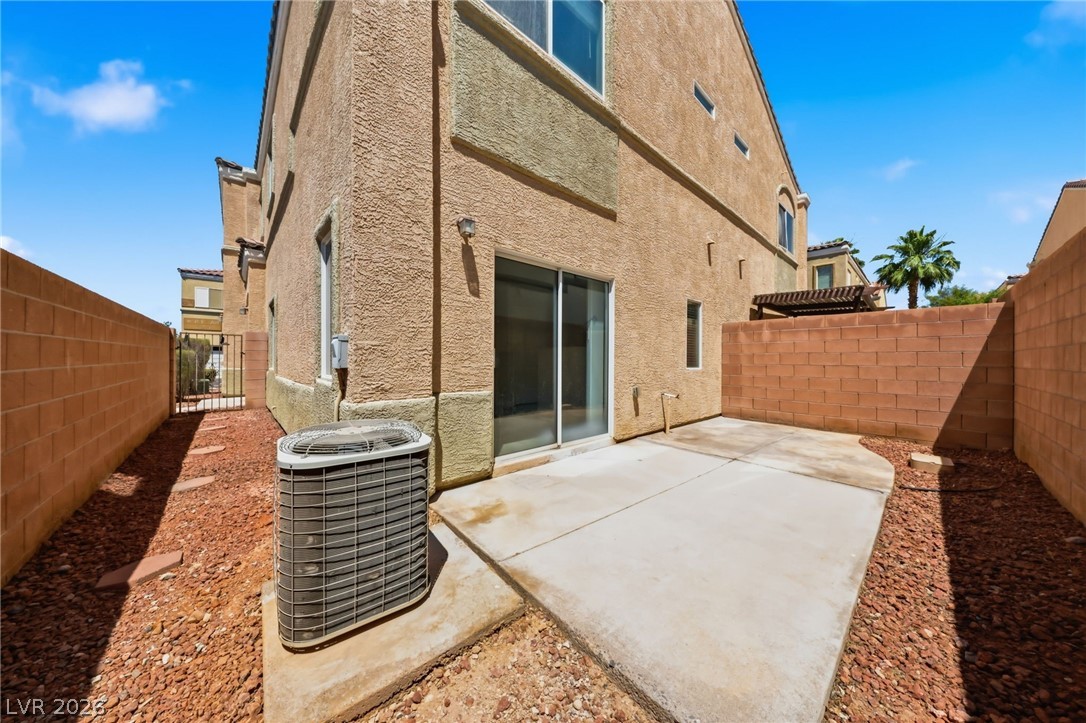 6312 Sandy Ridge Street, Unit 3102 North Las Vegas, NV 89081 - Photo 29 of 31 A private backyard patio with desert-friendly landscaping, ideal for outdoor enjoyment.