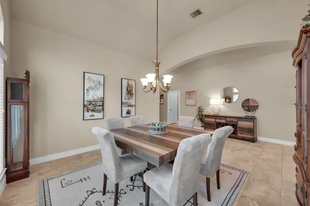 a living room with furniture a flat screen tv and kitchen view