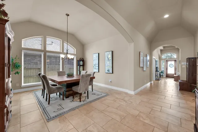 a living room with stainless steel appliances granite countertop furniture and a fireplace