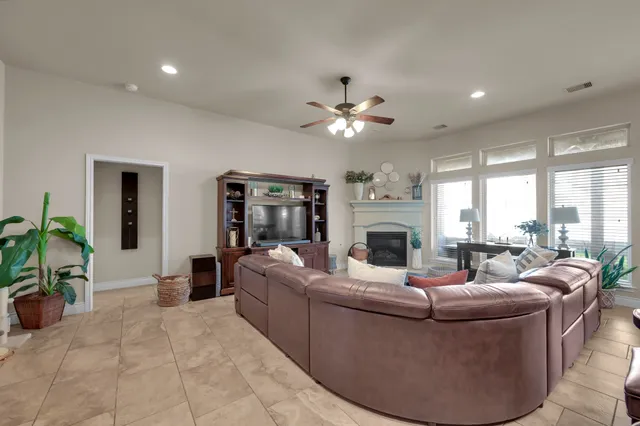 a kitchen with stainless steel appliances granite countertop a table chairs sink refrigerator and cabinets