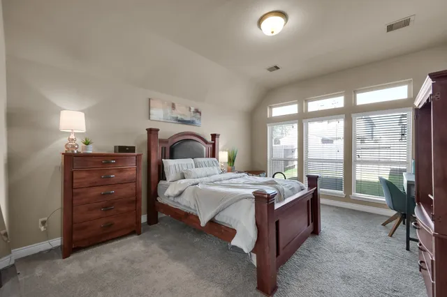 a bedroom with a bed and a chair