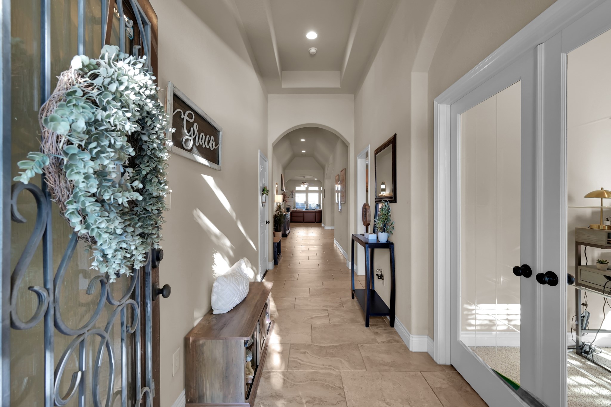 3814 Trophy Ridge Spring, TX 77386 - Photo 4 of 39 This welcoming entryway features a long hallway with high ceilings and elegant archways. It leads to a well-lit living area, with French doors on the right opening into a cozy room.