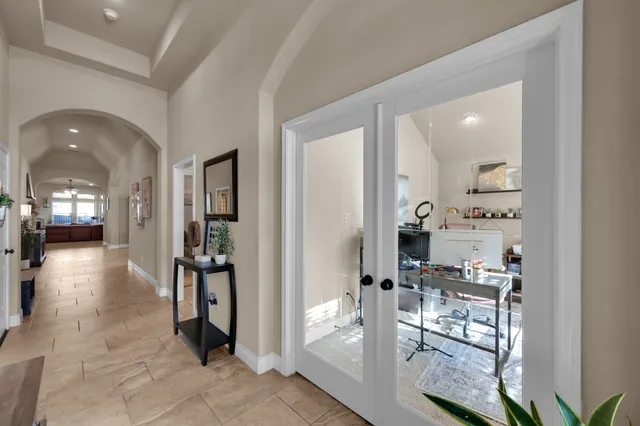 a living room with furniture and a book shelf