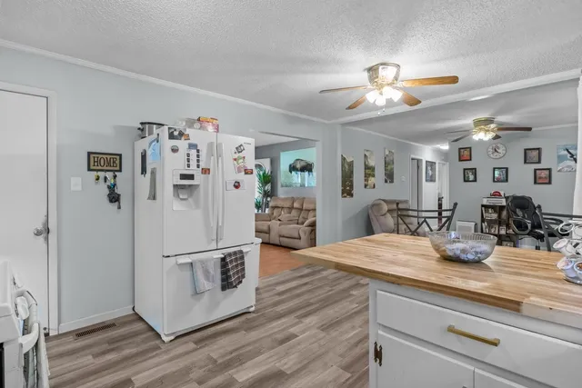 a kitchen with stainless steel appliances granite countertop a refrigerator and a sink