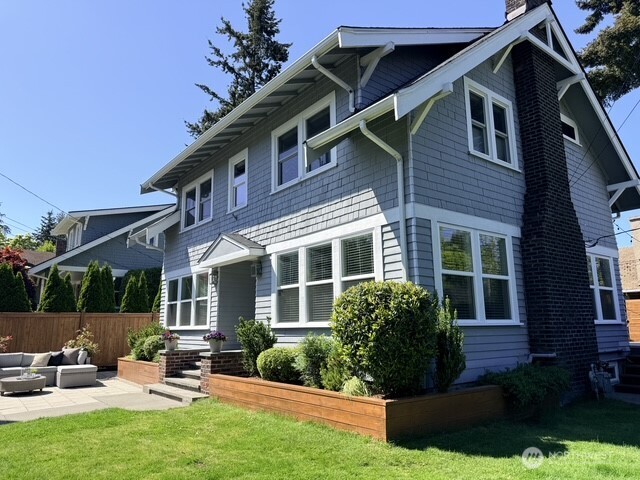 170 Lynn Street Seattle, WA 98109 - Photo 1 of 40 a view of the house with backyard sitting area and garden