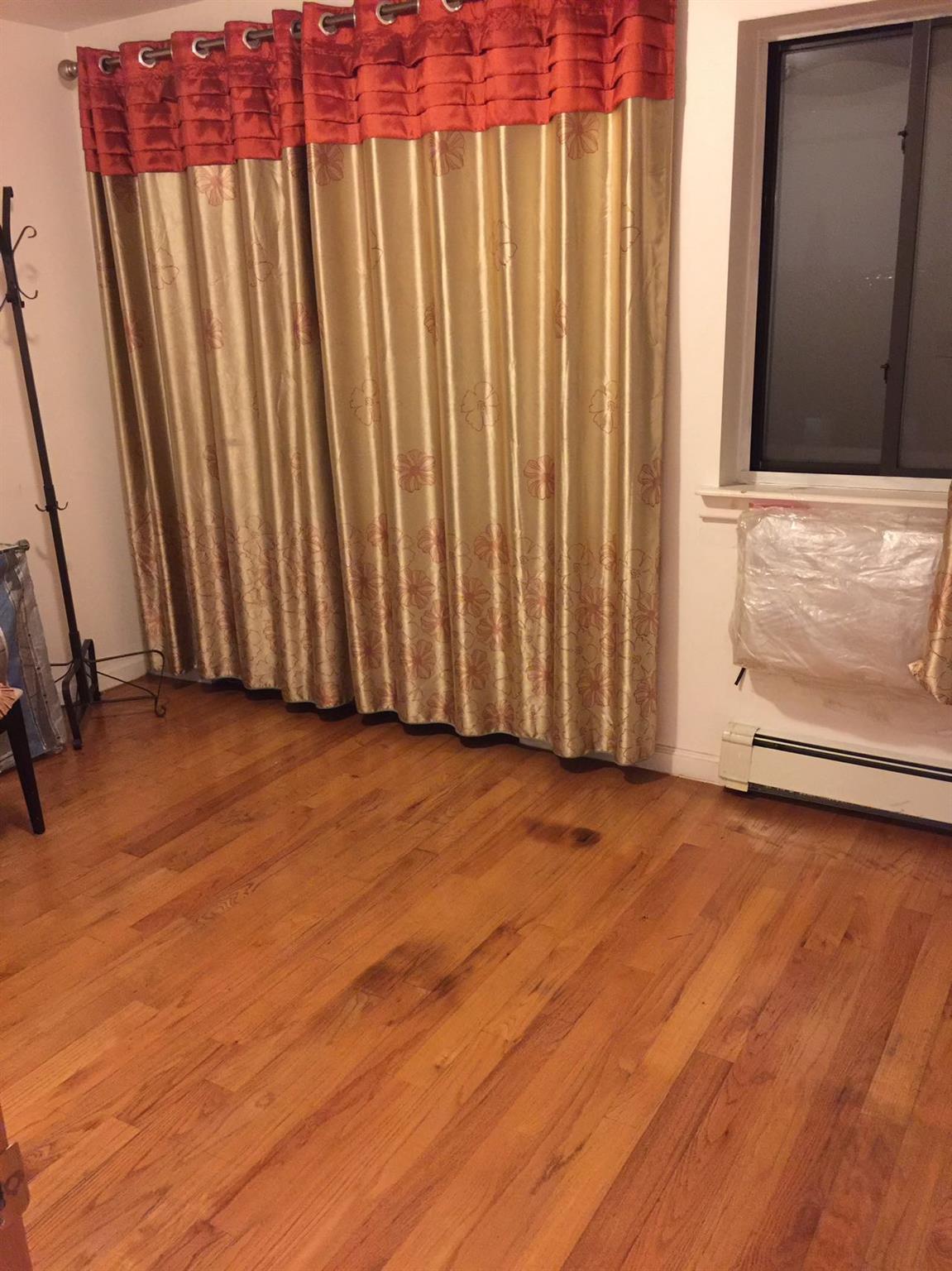 37-33 107th Street, Unit 4A Queens, NY 11368 - Photo 5 of 7 a view of a door with wooden floor