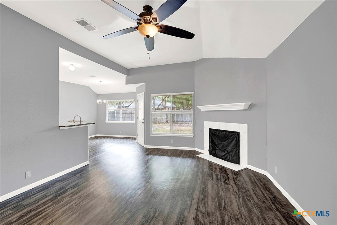 140 Riley Cove Kyle, TX 78640 - Photo 6 of 26 a view of an empty room with window and wooden floor