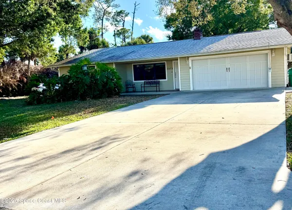 a view of a house with a yard and sitting area
