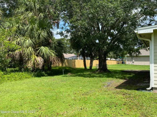 a kitchen with a refrigerator a stove top oven a sink and dishwasher with wooden floor