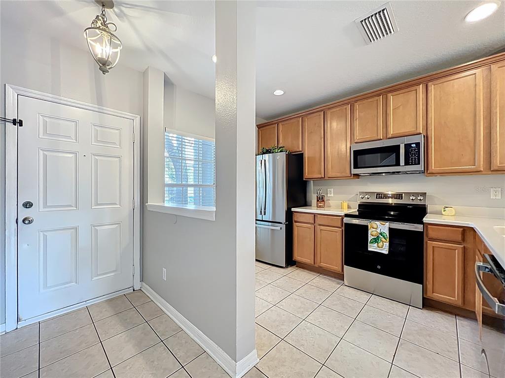 3309 Wilshire Way Road, Unit 3 Orlando, FL 32829 - Photo 5 of 43 a kitchen with granite countertop a refrigerator stove top oven and sink