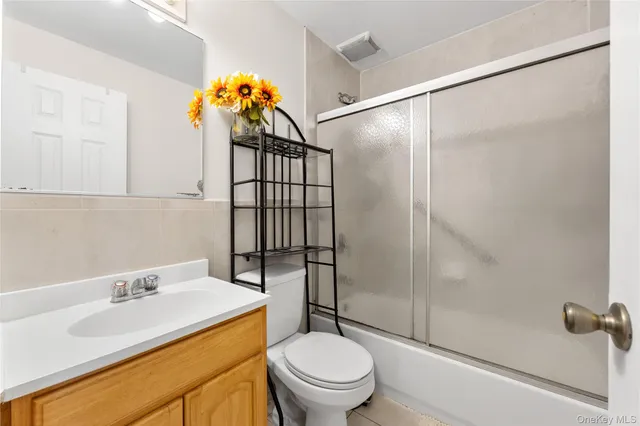 a bedroom with bed and a view of living room