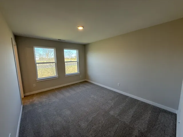 a bathroom with a sink a toilet a mirror and shower
