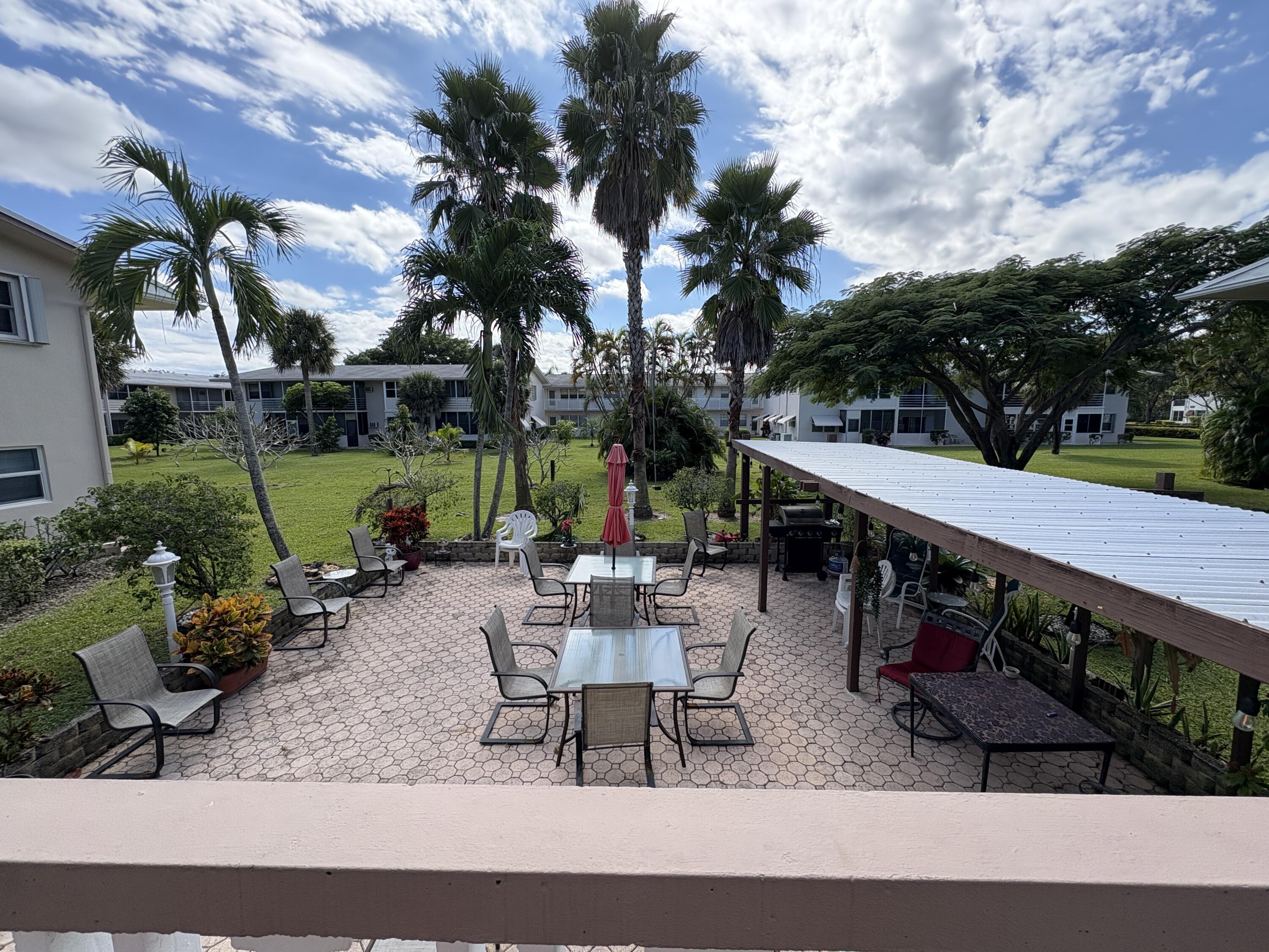 113 Waltham East West Palm Beach, FL 33417 - Photo 11 of 24 a view of a patio with chairs and a table