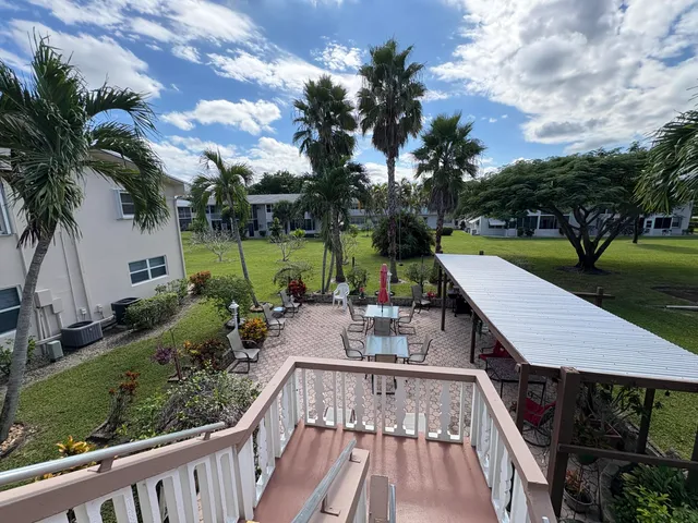 a view of a swimming pool with a patio and a garden