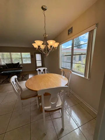 a dining room with a table and chairs