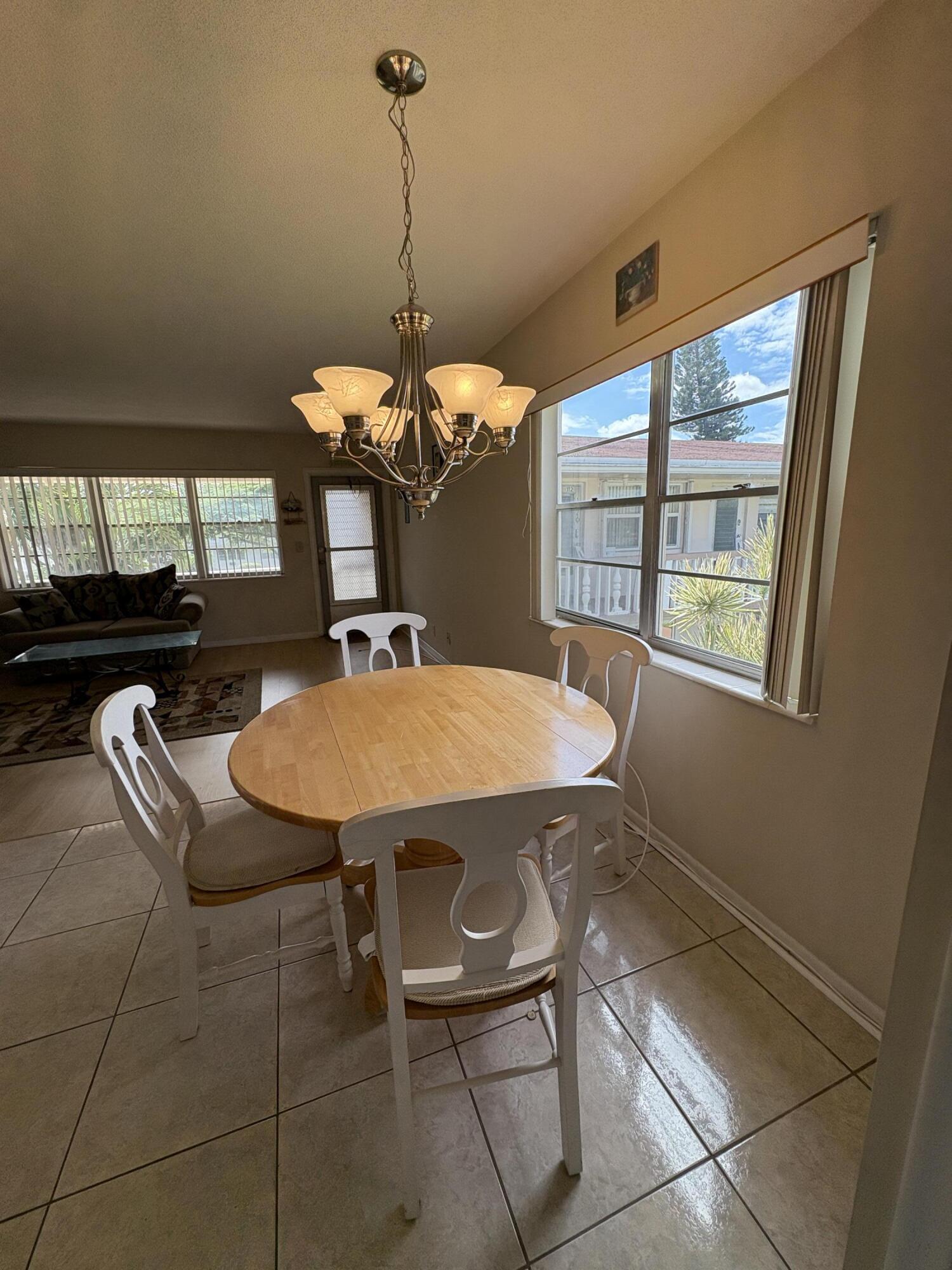 113 Waltham East West Palm Beach, FL 33417 - Photo 16 of 24 a dining room with a table and chairs