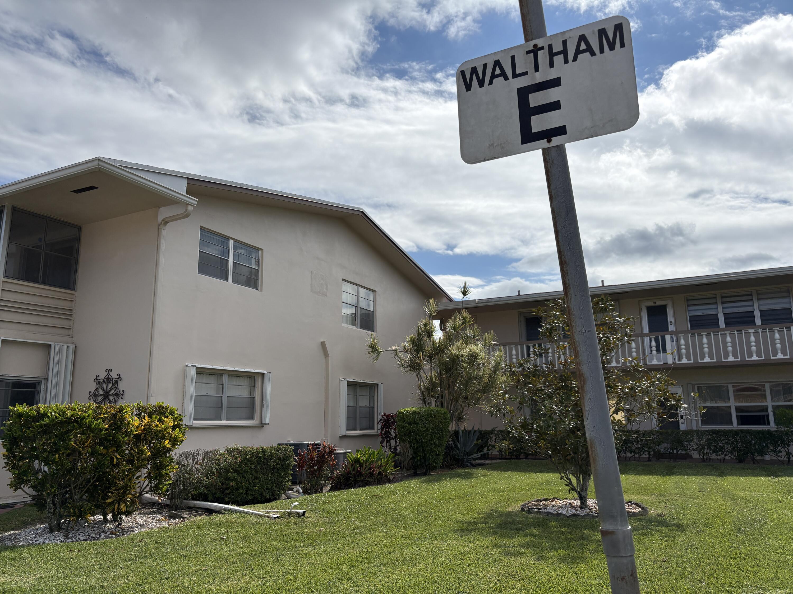 113 Waltham East West Palm Beach, FL 33417 - Photo 3 of 24 a front view of a house with garden