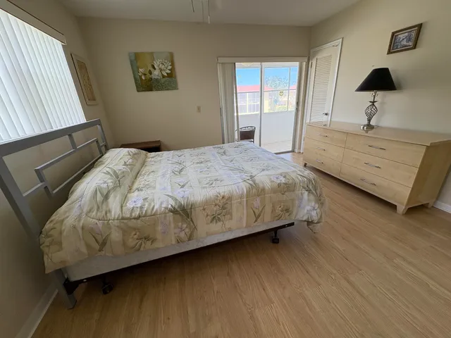 a bedroom with a bed and a night stand