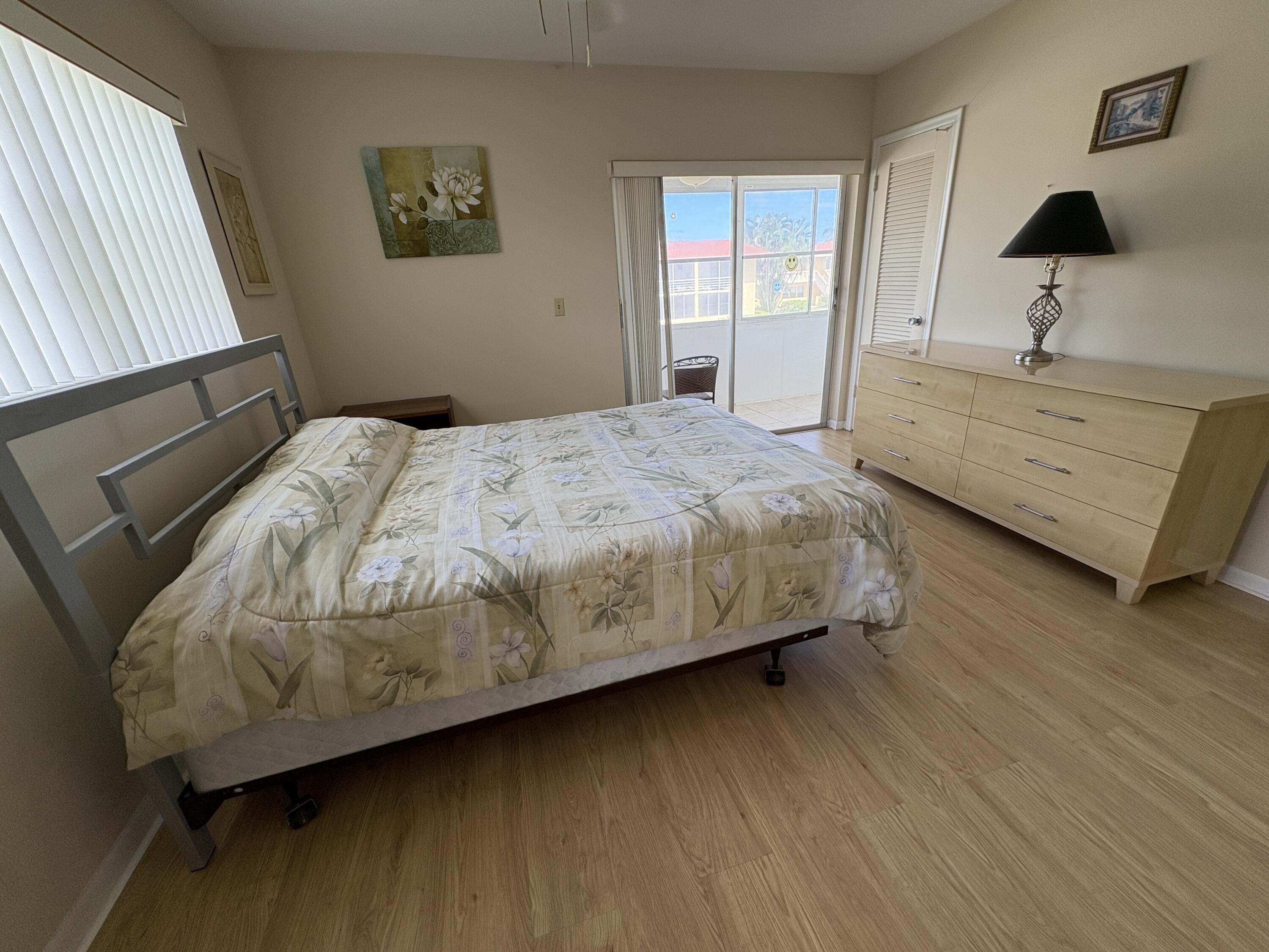 113 Waltham East West Palm Beach, FL 33417 - Photo 4 of 24 a bedroom with a bed and a night stand