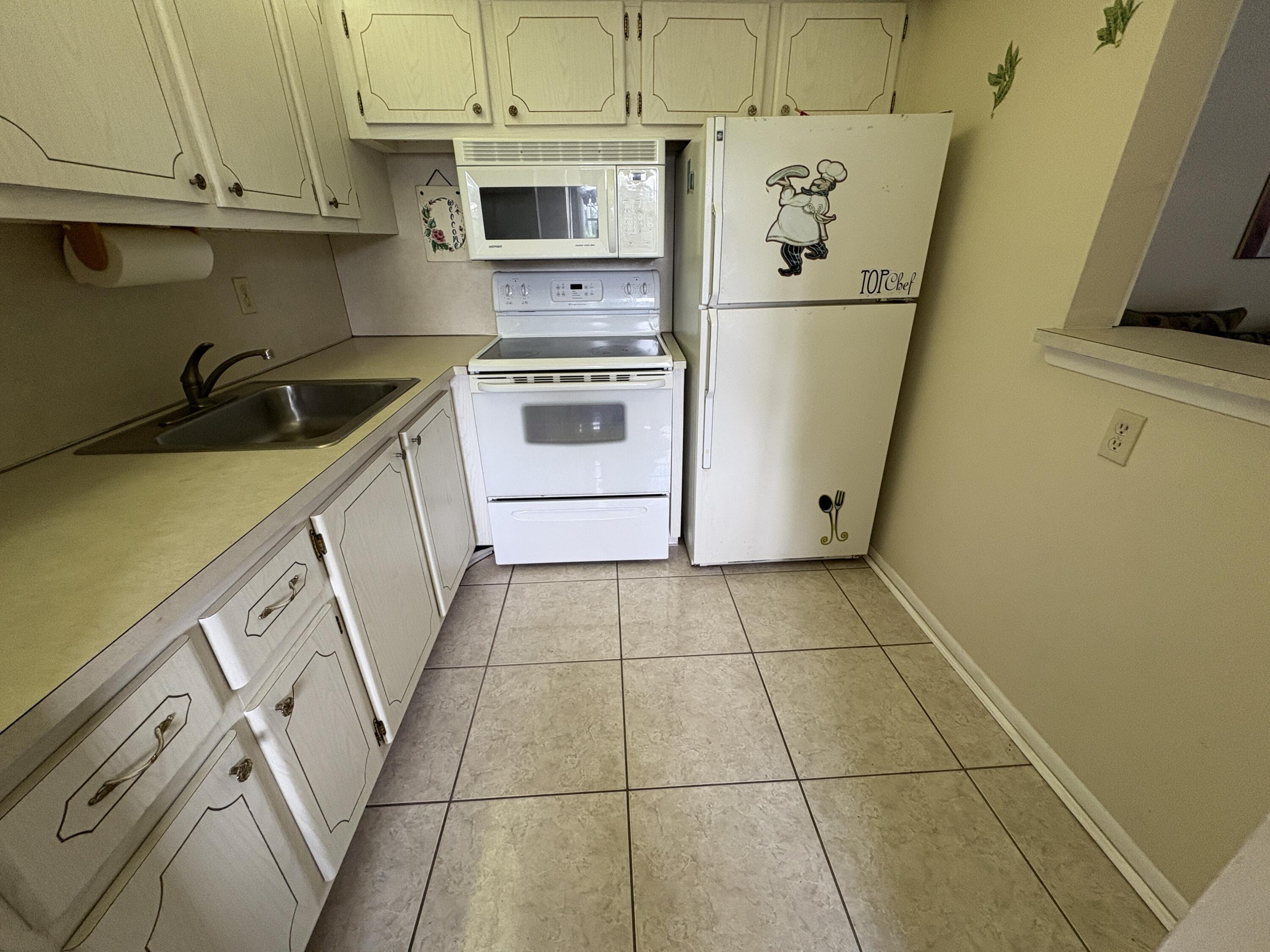 113 Waltham East West Palm Beach, FL 33417 - Photo 7 of 24 a view of a kitchen with appliances