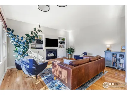 a living room with furniture a potted plant and a flat screen tv