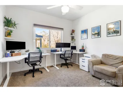 a workspace with a couch and a flat screen tv