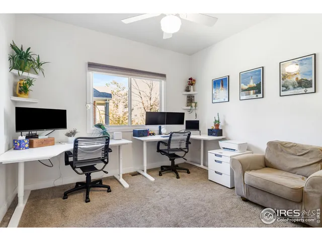 a workspace with a couch and a flat screen tv