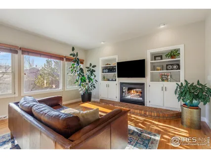 a living room with a fireplace and a flat screen tv