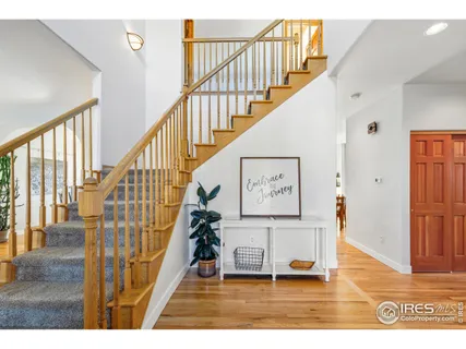 a view of entryway and hall with wooden floor