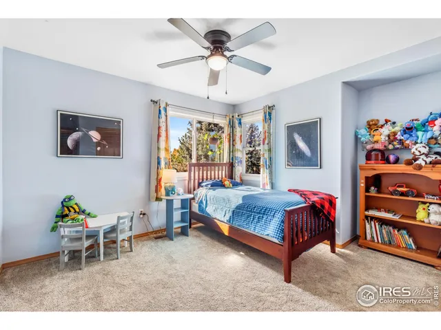 a living room with a bed and a chandelier