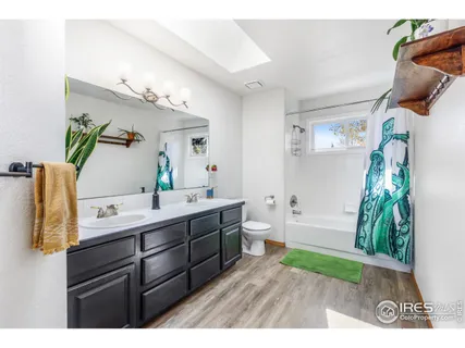 a bathroom with a tub sink and mirror