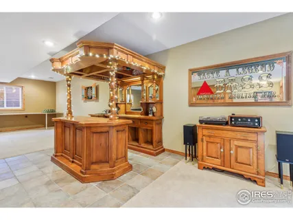 a living room with fireplace furniture and a kitchen view