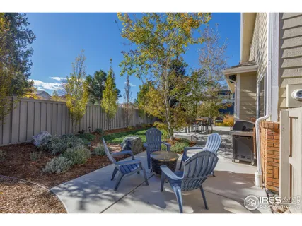 a view of a chairs and table in backyard