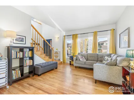 a living room with furniture and a book shelf