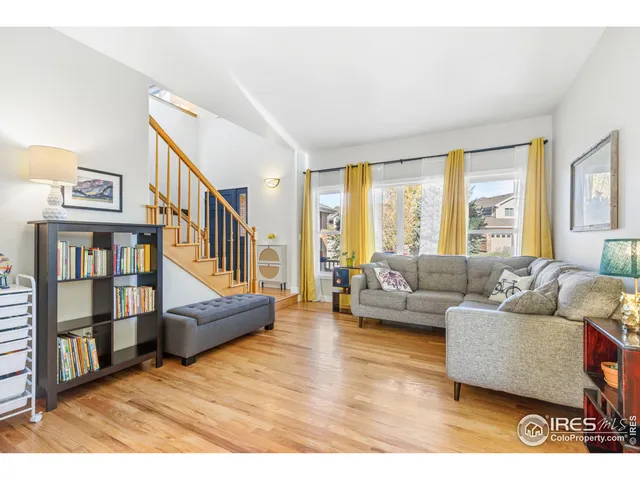 a living room with furniture and a book shelf