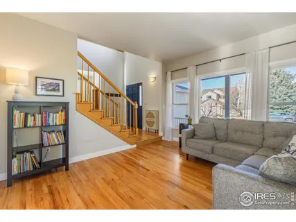 a living room with furniture and a book shelf