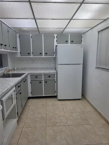 a utility room with cabinets washer and dryer