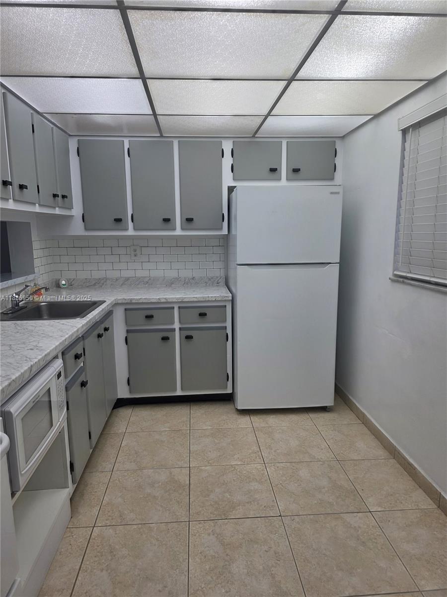 a utility room with cabinets washer and dryer