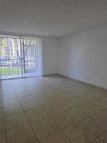 a view of an empty room and a window