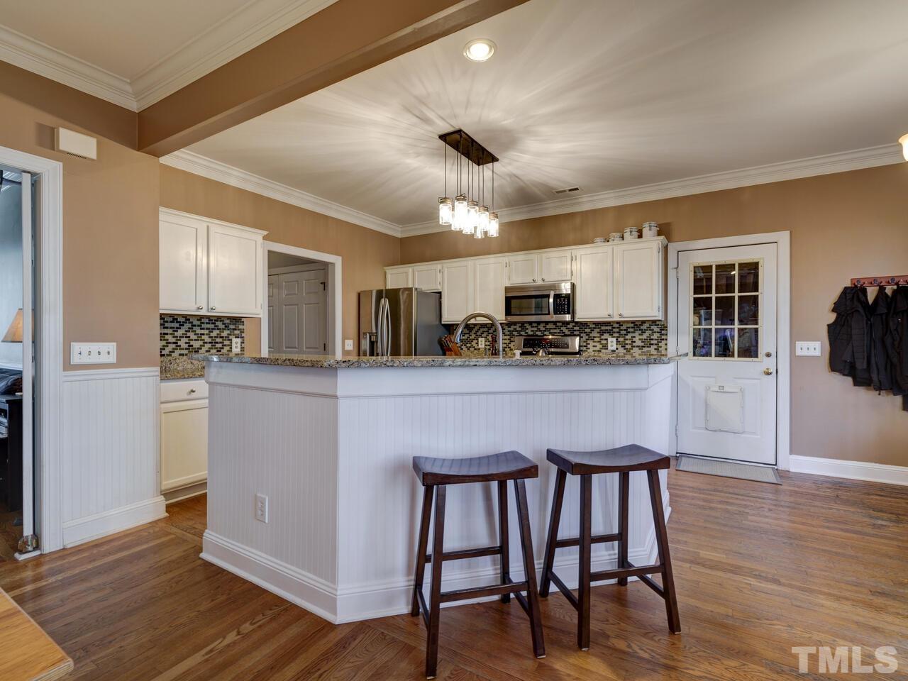 11816 Radner Way Raleigh, NC 27613 - Photo 10 of 54 a kitchen with stainless steel appliances granite countertop a table chairs refrigerator and sink
