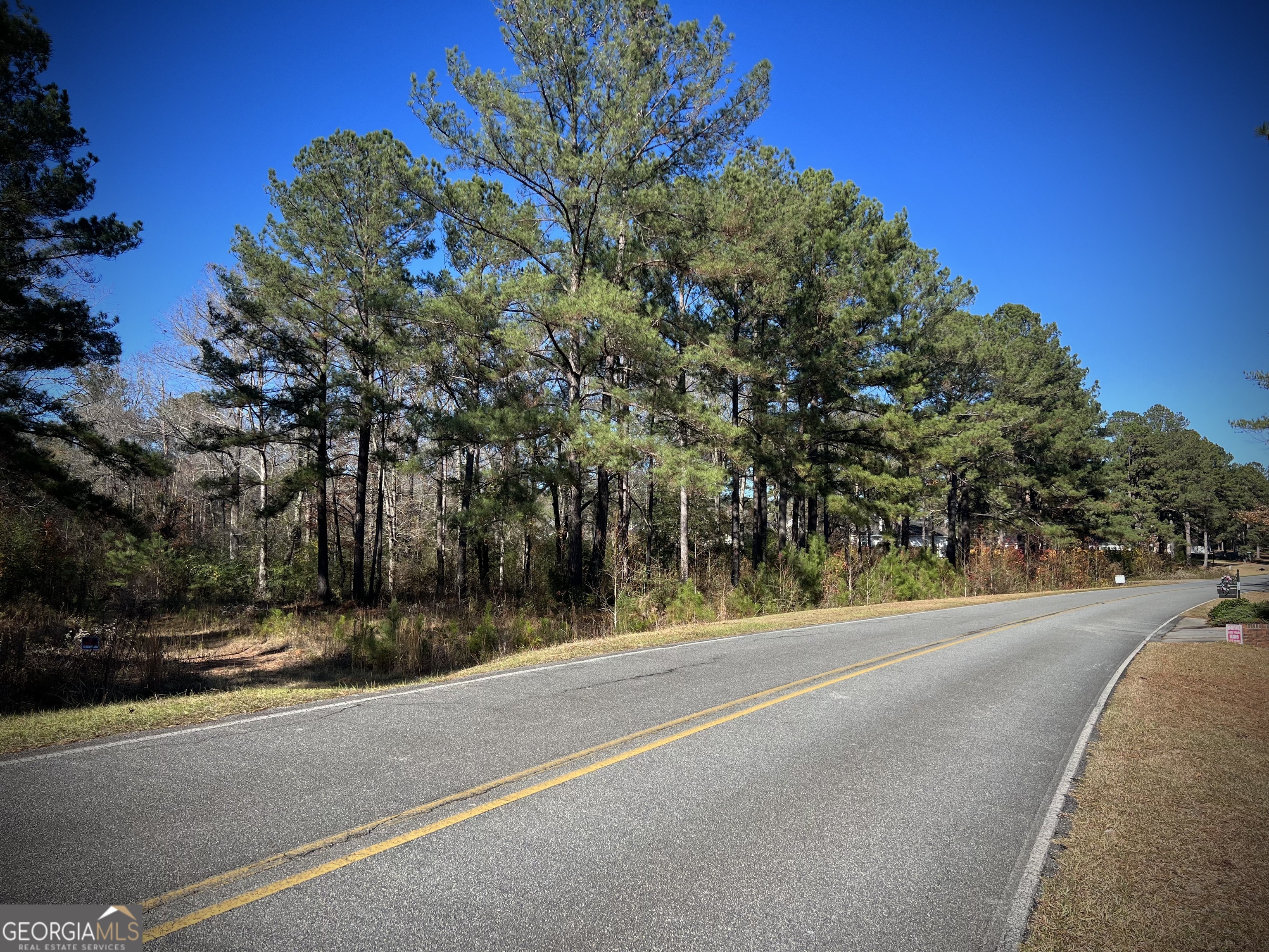 a view of a street with a building in the background