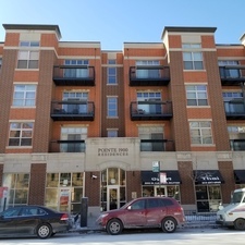 1910 South State Street, Unit 409 Chicago, IL 60616 - Photo 1 of 3 a front view of residential building with cars parked