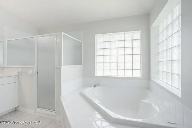 a white bath tub sitting next to a window