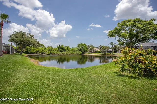 a view of a lake with houses in the back