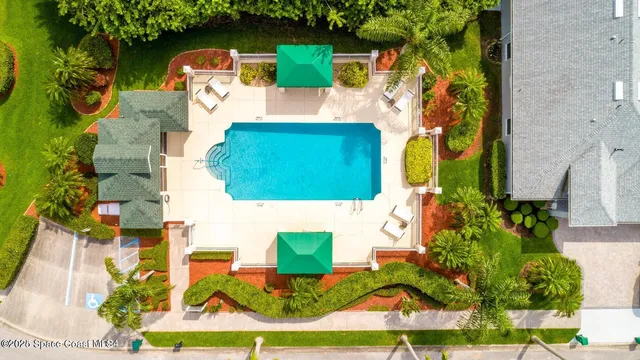 an aerial view of a house with a yard and potted plants